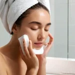 Home 10 피부과 자가 관리법 - **Prompt 1: Evening Cleansing Ritual**
A serene woman in her late 20s, with clean, tied-back hai...